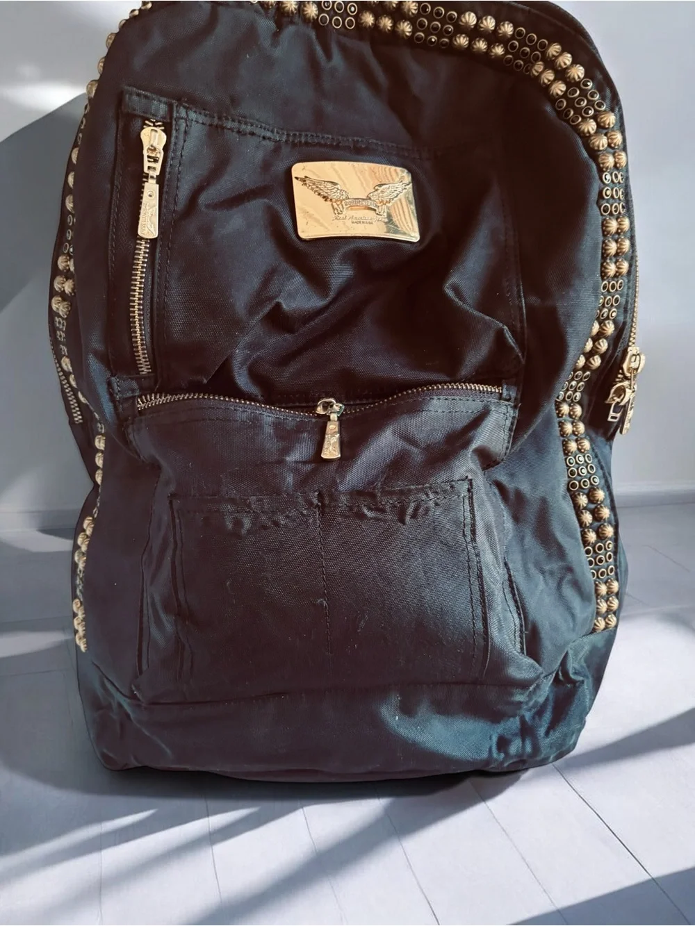 Jean Studded Backpack designed with an edgy  streetwear aesthetic.